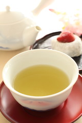 Japanese green tea with wagashi on background
