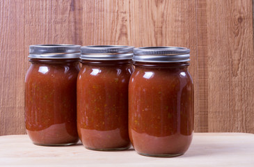 Three jars of homemade tomato sauce