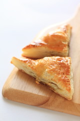 homemade meat pie on wooden bread board