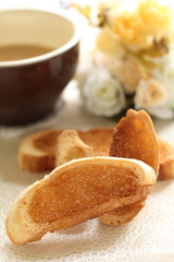 Homemade Rask and hot coffee with flower on background