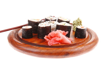 sushi rolls on wood with wasabi and ginger
