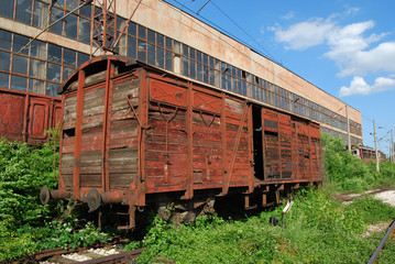 Fototapeta na wymiar Vintage industrial building and old wooden wagon