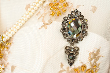 gray brooch pin on the bride dress