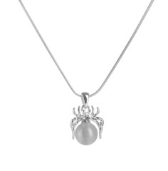 Pendant in form of spider with pearl isolated on white