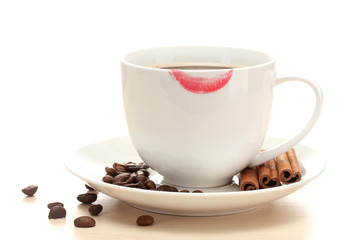 cup of coffee with lipstick mark beans and cinnamon sticks
