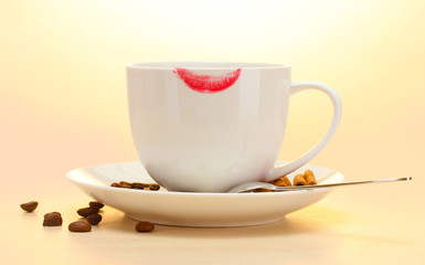 cup of coffee with lipstick mark beans and cinnamon sticks