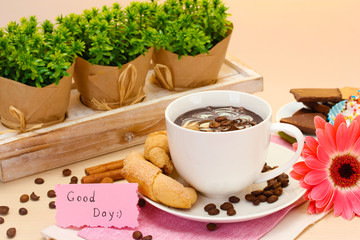 cup of coffee and gerbera  beans, cinnamon sticks