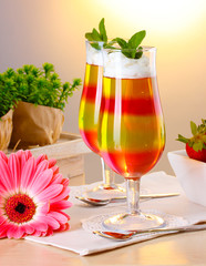 fruit jelly in glasses and fruits on table in cafe