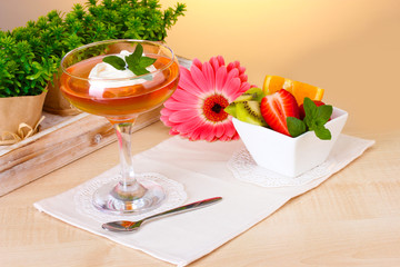 fruit jelly in glass and fruits on table in cafe