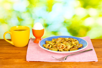 Fried zucchini with eggs and coffee for breakfast