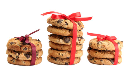 Chocolate chips cookies with red ribbons isolated on white.