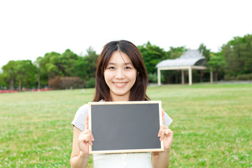 Fototapeta premium Beautiful young woman with message board. Portrait of asian.