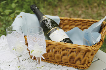 A pair of wedding glasses and basket