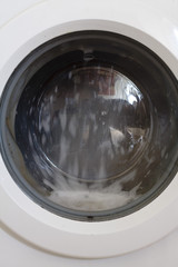 View of washing man drum spinning round on a wash cycle