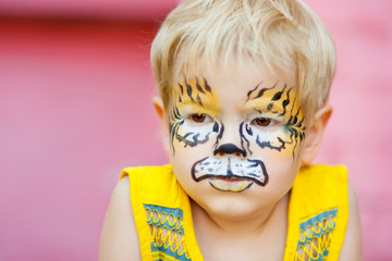 Beautiful boy with a body painting tiger