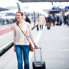 Pretty young woman at a train station (color toned image)