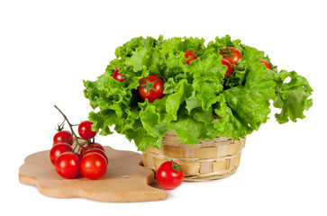 Red tomatoes in a basket with lettuce