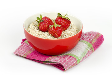 bowl with oatmeal and fresh strawberries