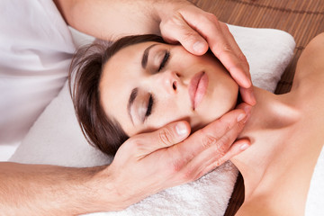 Fototapeta na wymiar Beautiful young woman getting face massage