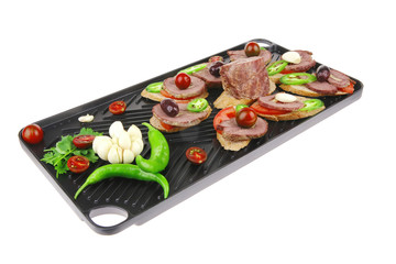 black teflon grill plate with meaty tartlets