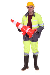 road worker holding a traffic cone