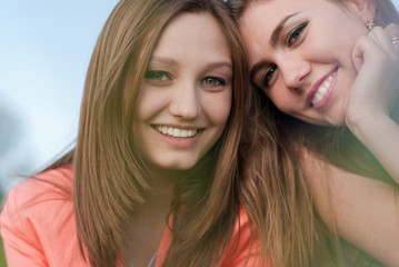 Fototapeta premium Two happy girl friends smiling