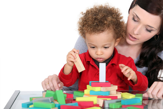 Woman and child playing with wooden blocks