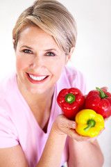 Senior woman with pepper. Diet.