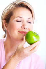 Senior woman with apple. Diet.