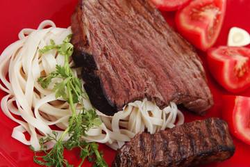 italian food : pasta with tomato and grilled sirloin