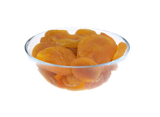 Dried apricots in glass bowl isolated on white background