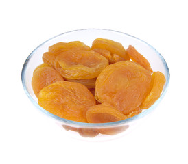 Dried apricots in glass bowl isolated on white background