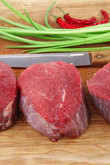 raw beef fillet on wooden board