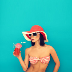 sensual  woman with sunglasses drinking a cocktail