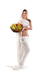 A young woman in white holding a basket full of fruits