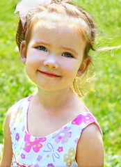 Cute little girl on the meadow in summer day