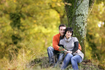 Couple sitting by a tree