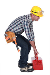 Worker with a heavy tool box