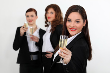 Young women in smart suit with glasses of champagne