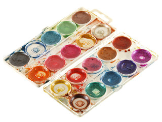 Old watercolour paints palette. Isolated on a white