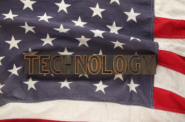 Fototapeta na wymiar the word technology in letterpress wood type on anAmerican flag
