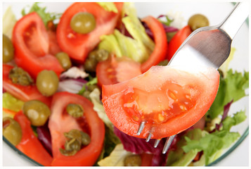 Fresh salad with fork, close up