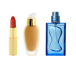 red lipstick in golden tube< makeup foundation and perfume isola