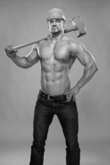 Young and handsome builder with a sledgehammer B&W