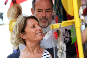 Obraz na płótnie Canvas Senior couple doing shopping in souvenir shop
