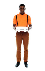 Full length portrait of delivery boy with pizza