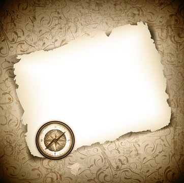 Vinatge antique compass at burned paper