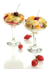 Fresh fruits salad and strawberries isolated on white