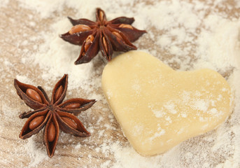 molded the dough with anise on wooden table close-up