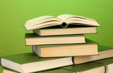 pile of books on green background close-up